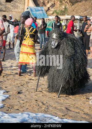 Dakar, Senegal - Feb, 2019: The Kumpo dance on the beach in Dakar. The Kumpo,  Samay, and the Niasse are three traditional figures in the mythology of Stock Photo