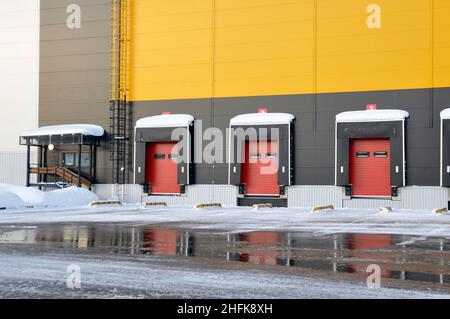 Exterior view of a large warehouse in winter. Loading docks. Stock Photo
