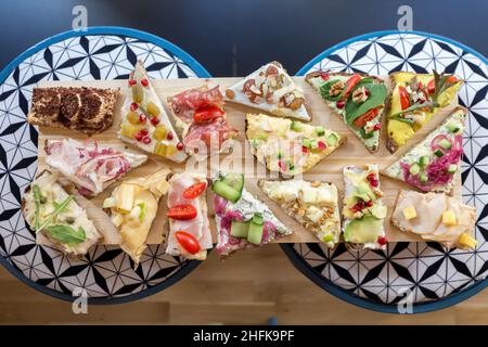 Plate with Scandinavian style open-faced colorful sandwiches. Stock Photo
