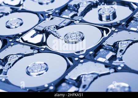 An array of hard drives with open covers, tinted blue. Data storage concept Stock Photo