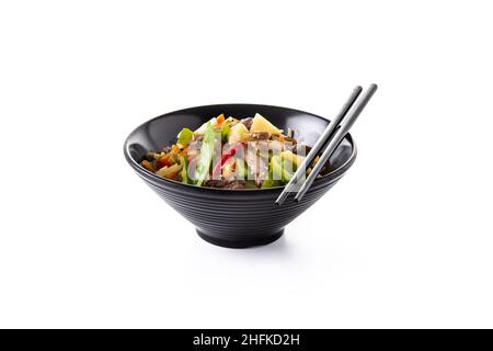Beef, vegetables and sesame seeds in black bowl isolated on white background Stock Photo
