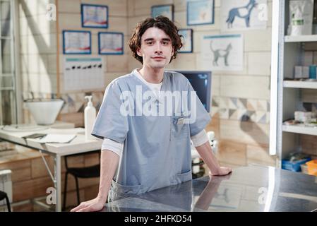 Portrait of young male vet doctor in uniform looking at camera while standing at vet office Stock Photo