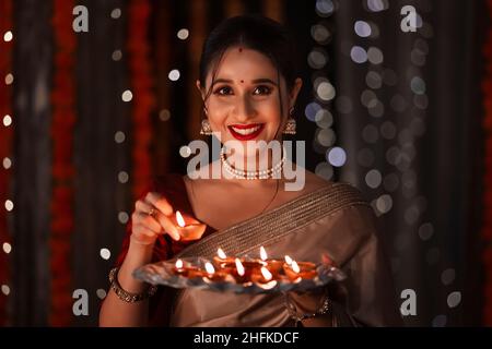 Happy Indian Young Woman Enjoy Playing firecrackers Celebrating Diwali  Festival