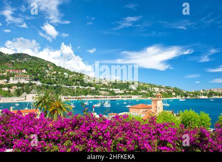 Mediterranean landscape with sea, sky, rhododendron flowers. French reviera, view of Villefranche-sur-Mer near Nice and Monaco Stock Photo