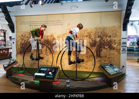 Penny farthing bicycle race display in the musuem of Much Wenlock, Shropshire, England Stock Photo