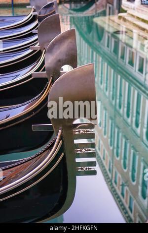 Detail on the steel bow of Venetian gondolas moored in Venice, Italy. Stock Photo