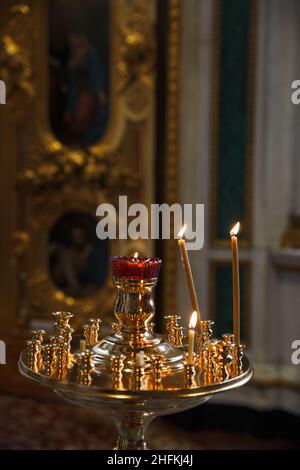 Altar and candles. Interior in the temple Orthodox Church. Christianity. Festive interior decoration with burning candles and icon. The ceremony of