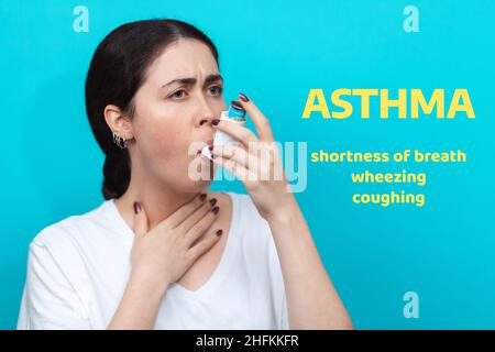 Portrait of a woman inhaling medication during an asthma attack. Blue ...