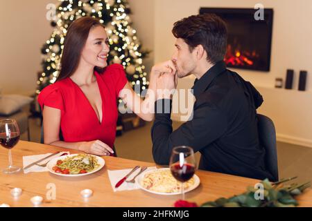 Romantic young man kissing his beloved woman's hands Stock Photo