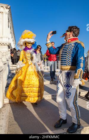 Man and woman in baroque fancy dress historic costumes take selfie at Venice Carnival, Carnevale di Venezia, Italy Stock Photo