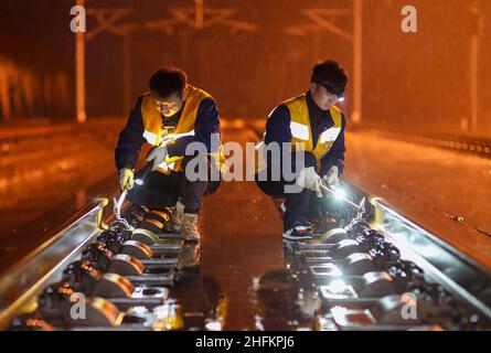 (220117) -- GUIYANG, Jan. 17, 2022 (Xinhua) -- Staff members check equipments at the Tongren South Railway Station in Guiyang, southwest China's Guizhou Province, Jan. 17, 2022. China's 2022 Spring Festival travel season is expected to see 1.18 billion passenger trips, up 35.6 percent year on year, but 20.3 percent lower than that of 2020, the Ministry of Transport has said. The 40-day travel season, also known as chunyun, kicked off Monday and many people will travel to reunite with their families for the Lunar New Year, or the Spring Festival, which falls on Feb. 1 this year. (Photo by H Stock Photo