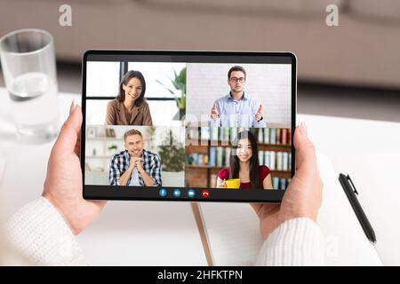 Group Video Chat. Female Hands Holding Digital Tablet With Online Conference Interface Stock Photo