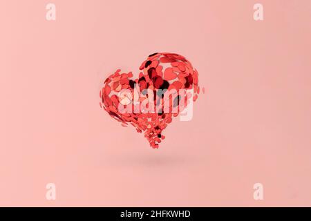 red heart is a symbol of love made of sequins on a pink background, minimalism. Stock Photo