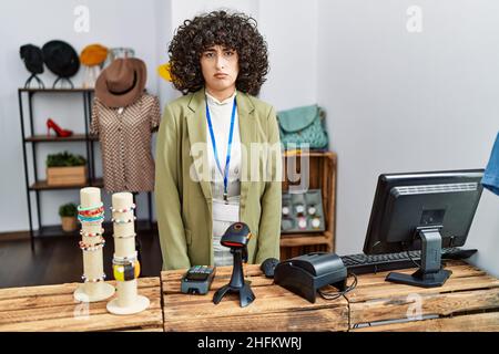 Young middle eastern woman working as manager at retail boutique skeptic and nervous, frowning upset because of problem. negative person. Stock Photo