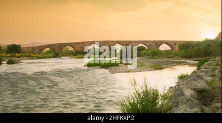 Cobandede bridge at sunset. The historical bridge over the Aras River.Turkey's most important historical stone bridges. Koprukoy district -  Erzurum -