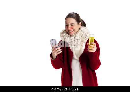 Portrait of young Caucasian girl feeling sick, has running nose isolated over white studio background. Flu, cold, allergy Stock Photo