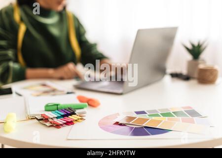 Unrecognizable Clothing Designer Woman Using Laptop Working Online In Office Stock Photo