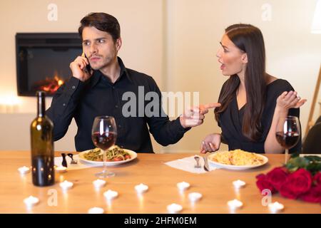 Angry Woman On Date, Man Talking On Mobile Phone Stock Photo