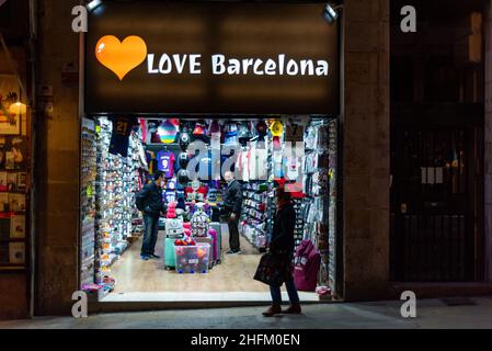A souvenir shop owner is seen inside in his shop as tourists pass by in the Ramblas of Barcelona, Spain on January 15, 2022. The hospitality and tourism industries have again been hit by the spread of the new Omicron variant of Covid-19. (Photo by Davide Bonaldo/Sipa USA) Stock Photo