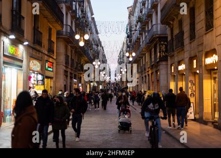 Tourists and locals walk and shop among bars, restaurants and shops in the commercial street Carrer Ferran of Barcelona, Spain on January 15, 2022. (Photo by Davide Bonaldo/Sipa USA) Stock Photo
