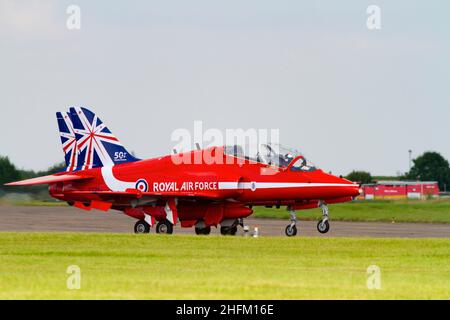 Two BAE Hawk T1a aircraft of the Royal Air Force aerobatic display team, The Red Arrows, with the 50th Anniversity tail markings. Accelerating to take Stock Photo