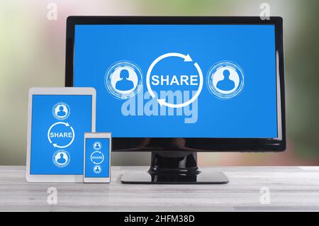 Share concept shown on different information technology devices Stock Photo