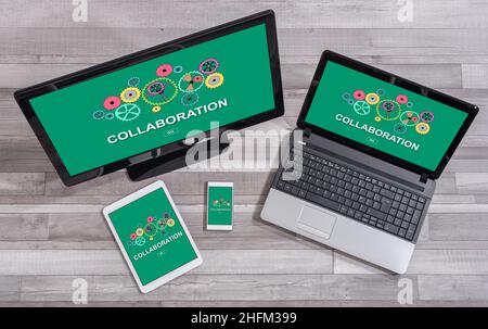 Collaboration concept shown on different information technology devices Stock Photo