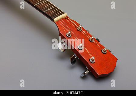 guitar headstock with metal pegs on a gray background. High quality photo Stock Photo