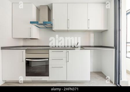 Kitchen with white stone countertops, bright purple wood cabinets