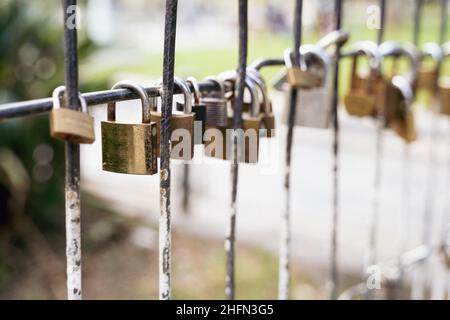 Several padlocks attached to fence. Couple love commitment concept Stock Photo