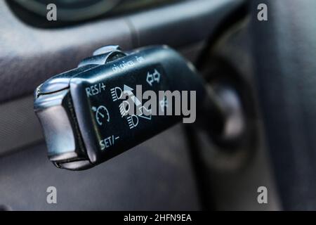 Cruise control and turns switch buttons close up in the new car. Signal switch for turn left or right and open lighting car. Stock Photo