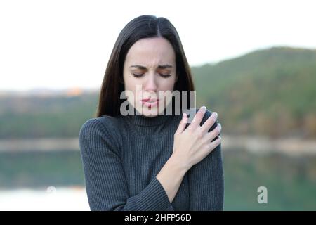 Front view portrait of a woman getting cold in winter in a lake Stock Photo