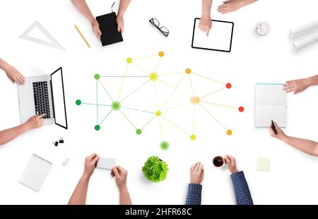 Professional networking concept with people siting on work desk and networking pins in the middle. Green, yellow, orange, red wires on white desk. Top Stock Photo