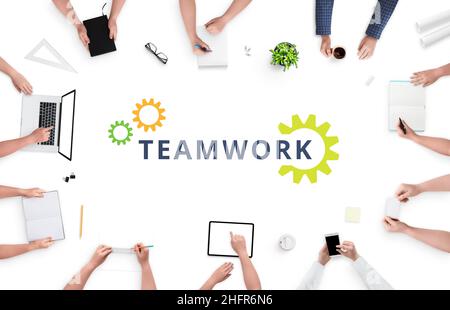 Teamwork concept with people on work desk and text in the middle. People work hard together on project. Top view, flat lay Stock Photo