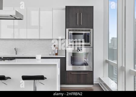 Stylish kitchen with with elegant shiny table and stove Stock Photo - Alamy