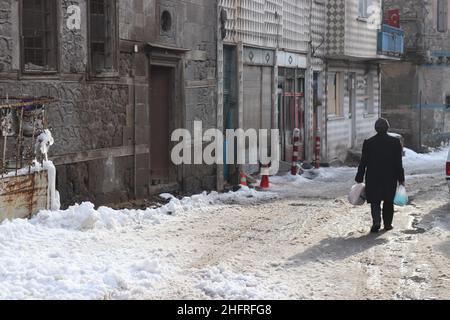 A man returning from shopping in the streets of Erzurum. Stock Photo