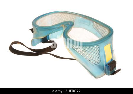 Dirty safety goggles on a white background, as used on construction sites. Stock Photo