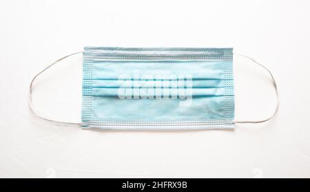 Medical mask isolated on white background. Surgical mask with rubber ear straps for mouth and nose cover. Stock Photo