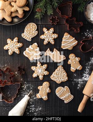 Overhead of christmas shaped gingerbread cookies on black table. Stock Photo