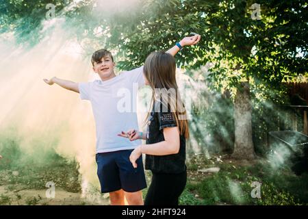 Teen boy smiling and playing in smoke bomb Stock Photo