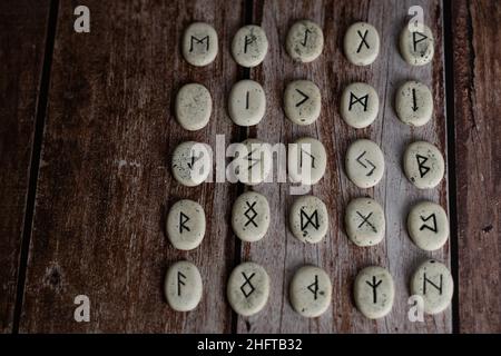 rune stones with black symbols for fortune telling Stock Photo