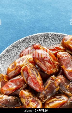 Close up picture of sweet dried dates on a plate, selective focus. Stock Photo