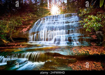 Sun setting over Grogan Creek Falls (or Falls on Grogan Creek) located in Pisgah National Forest near Brevard NC. Stock Photo