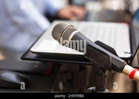 Studio microphone near computer and DJ mixing console to create music and songs in the studio. Microphone and studio equipment for DJ performance at a Stock Photo
