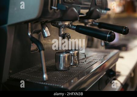Close up of the process of making espresso in a professional coffee machine. Stock Photo