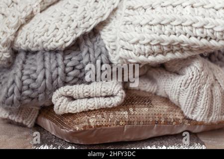 Close up of neatly folded knitted items of pastel color. Stock Photo