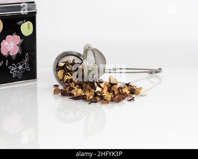 Dry loose tea hibiscus on a white background Studio Photo, macro, many details, tea strainer, tea box in the background Stock Photo