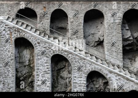 Architectural details in close-up of monochrome rough stone pillars, arches and staircase of supporting wall structure in Chamoix France Stock Photo