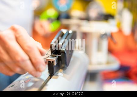 manual stringing of a badminton racket in service Stock Photo