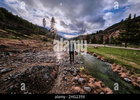 A young woman following the water at Kirkham hot springs. Stock Photo